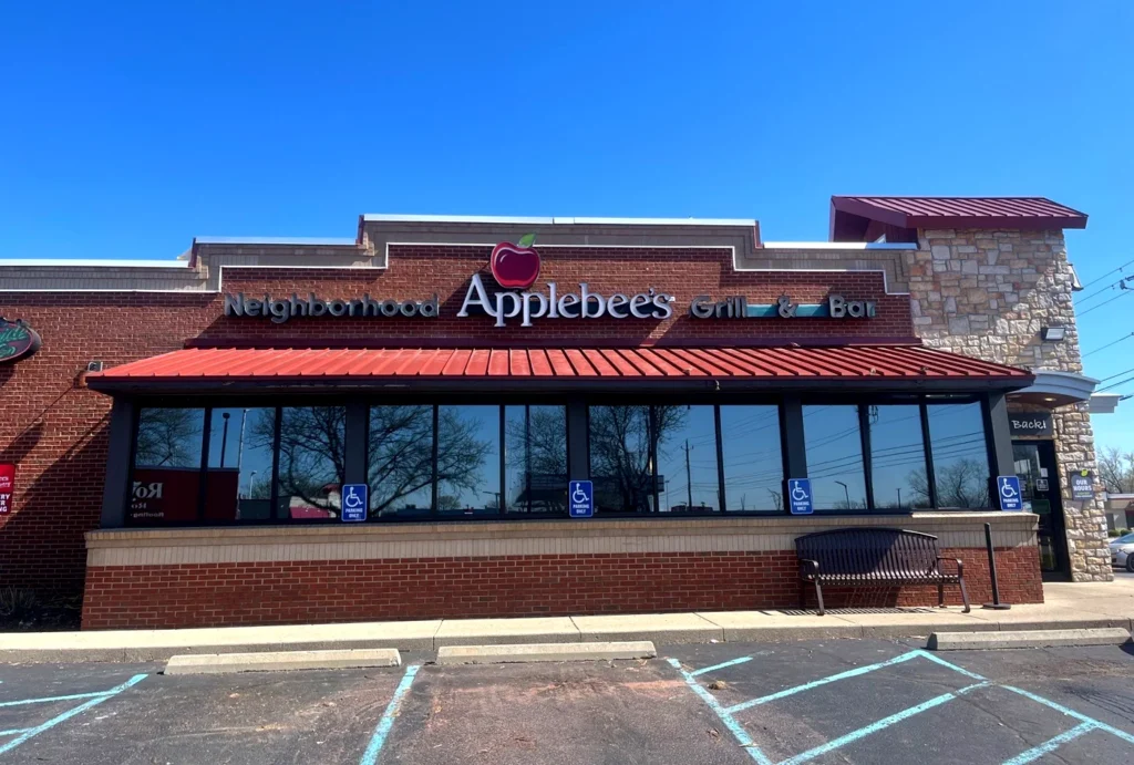 Commercial restaurant roofing project with custom metal awning installed on Applebee’s franchise