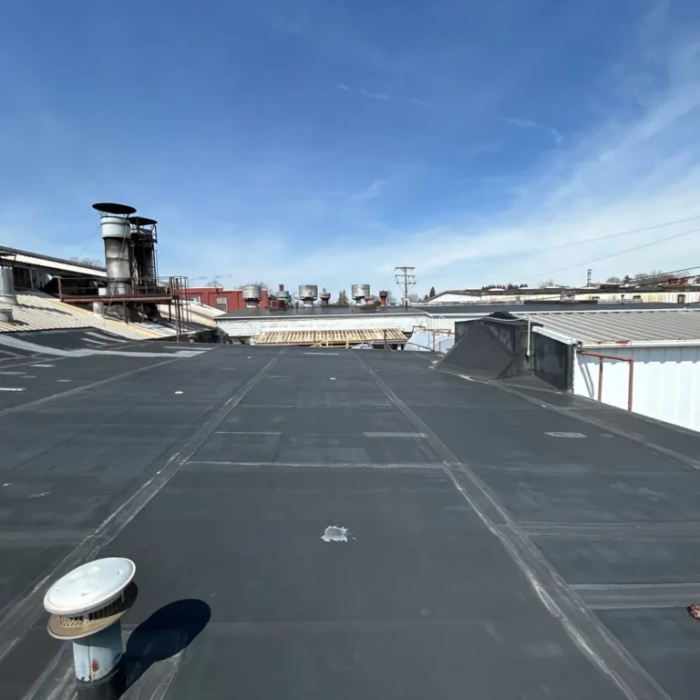 epdm roof on triangle suspension systems in dubois pa with measuring tape for commercial roof inspection prior to replacement